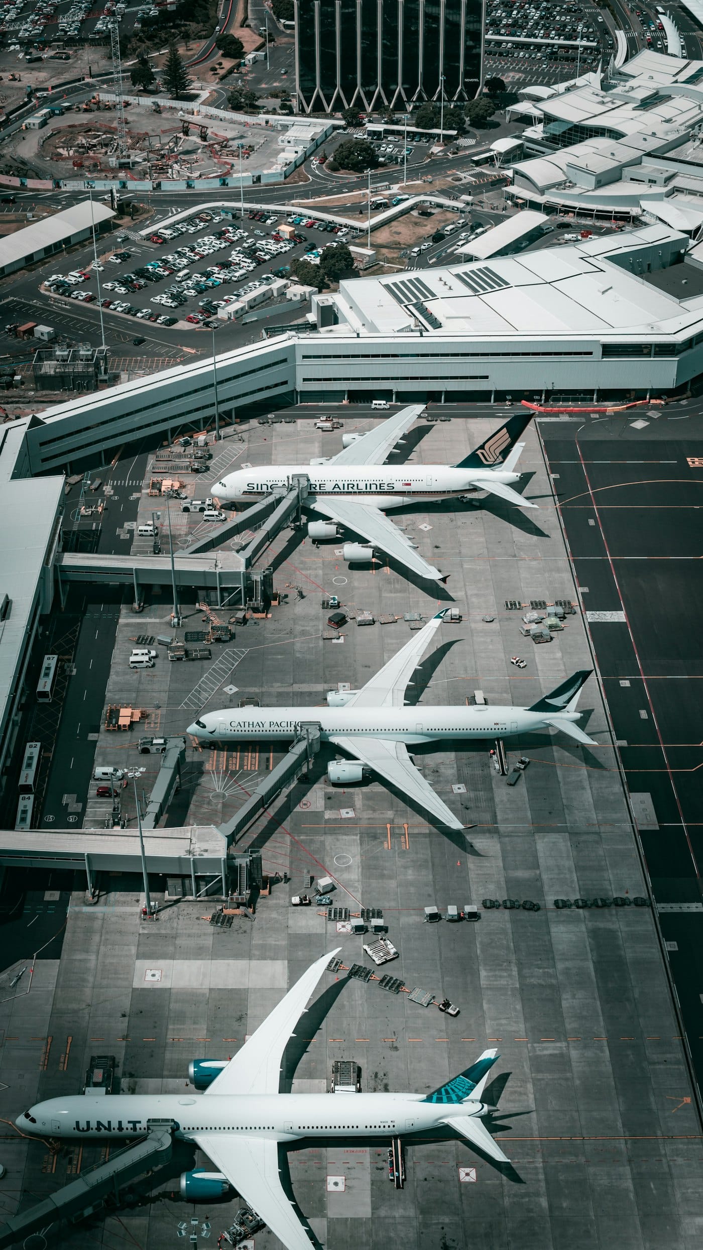 Aircraft, jet bridges and ground equipment at airport gates